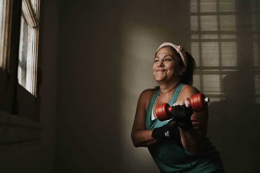 Mujer entrenando con mancuernas y técnica correcta